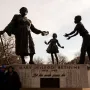 Mary McLeod Bethune Memorial bronze statue of Mary McLeod Bethune with two children reaching toward her.