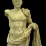 General of Tivoli marble statue of a draped male figure beside a small support, shown against a black background.