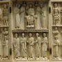 Harbaville Triptych with three carved ivory panels showing a central seated figure flanked by standing figures, busts in roundels, and inscriptions.