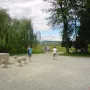 Table of Silence stone table with hourglass-shaped stools along a gravel path in a park