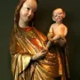 Madonna of Krużlowa holding the Christ Child, shown in flowing gold and red robes.