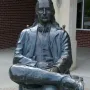 Wild Bill Hickok Memorial statue of a seated man with long hair, a mustache, and a bow tie