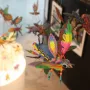 Brightly colored alebrije sculptures resembling insects and fantastical creatures hanging in a display.
