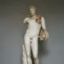 Hermes Belvedere marble statue of a standing nude male figure with curly hair and a draped cloak.
