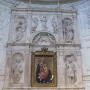 Piccolomini Altarpiece with a central painting of the Virgin Mary and Child, flanked by large marble statues and ornate sculpted panels.