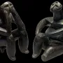 The Thinker of Cernavodă seated in a thoughtful pose beside the Sitting Woman of Cernavodă.
