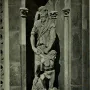 Stone relief of Abraham and Isaac, showing an older bearded man standing over a crouching, seminude younger figure in a carved niche.
