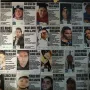 Wall covered with missing person posters at The Roundabout of the Disappeared.