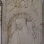 Tomb of Giovanni Crivelli stone relief with a carved effigy beneath a scalloped arch and winged figures above.