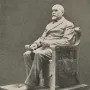 Timothy Eaton statue showing a seated bearded man in a double-breasted suit on a rectangular base.