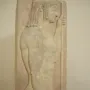 Grave stele with a relief of a youthful male figure in profile holding a staff.