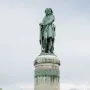 The Vercingetorix Monument, a green-patinated bronze warrior statue on a tall stone pedestal.