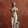 Venus Tauride marble statue with missing arms, standing beside a draped pillar.