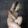Crouching Venus marble sculpture of a nude female figure in a crouching pose on a base.