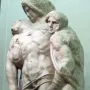 Palestrina Pietà marble sculpture with three intertwined figures, showing rough unfinished surfaces and chisel marks.