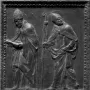 Relief panel from Donatello\'s Door of the Apostles showing two robed haloed figures, one holding a book and the other a staff.
