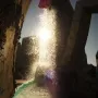 Vaillancourt Fountain with water splashing brightly in the sun between dark concrete structures.