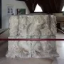 Stone relief blocks from the Pilier d\'Yzeures-sur-Creuse displayed in a museum setting.