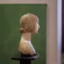Portrait of Eleanor of Aragon, a light stone bust shown in profile facing right with a covered head