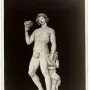 Michelangelo’s Bacchus, a marble statue of a nude male figure holding a goblet and grapes with a small satyr beside him.