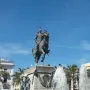 Bronze equestrian monument to Primo de Rivera on a tall stone pedestal, with fountains spraying around the base.
