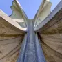 The Stone Flower monument rises in concrete petal-like forms against a clear blue sky.