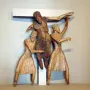 Wooden Descent from the Cross sculpture with a central figure being lowered from a beam by two robed figures, flanked by two crucified figures.