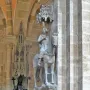 The Bamberg Horseman mounted on a horse and displayed high on a bracket inside a Gothic cathedral interior.