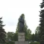 Mickiewicz Monument, a dark statue of a bearded man holding a book on a tall stone pedestal in a park.