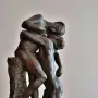 Sakuntala, a dark bronze sculpture of two nude figures in an embrace, with one standing and supporting the other kneeling.