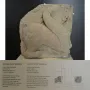 El Salobral sphinx sculpture displayed on a white pedestal with a museum information plaque below it.