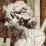 Damned Soul by Gian Lorenzo Bernini, a white marble bust with a screaming anguished face and wild curly hair behind glass.
