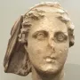 Lycosoura Demeter stone head with worn facial features and a draped veil-like covering