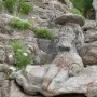 Rothéneuf Sculpted Rocks showing a bearded man carved into granite with a flat hat.