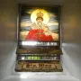 Stained glass depiction of Santo Niño de Cebú wearing a crown and red robes, holding an orb with a halo behind him.