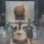 Stone of Motecuhzoma I circular carved monolith displayed in a museum hall