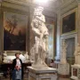 A marble sculpture of Aeneas, Anchises and Ascanius showing a man carrying an older man while a child clings to his leg.