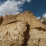 Ardashir Investiture Relief carved into a cliff, showing two mounted figures in a ceremonial exchange with smaller figures below.
