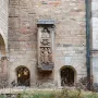 Tomb of Bruno the Priest carved in relief on a tall stone monument set into a church wall.