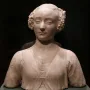 Marble bust of a young woman with tightly curled hair and an ornate carved garment.