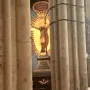 Gero Cross crucifix with Christ before a golden sunburst, framed by stone columns.