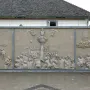 Ludwigs Erbe stone relief with three panels showing a crowded central monument scene and smaller figures on either side.