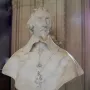 Bust of Cardinal Richelieu in white marble, showing curly hair, a mustache, a pointed beard, and a draped cape with a hanging cross medallion.