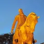 Leopold II equestrian statue in warm golden light against a twilight sky