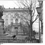 Goethe Monument stands on a tall pedestal in front of an ornate building in Leipzig.