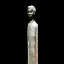 Ombra della Sera bronze figure with a long slender body and detailed head on a black background.