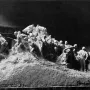 Wars of America sculptural model with warriors and horses advancing across textured terrain.
