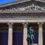 Frederick William IV equestrian statue in front of a classical building with columns and a sculpted frieze.