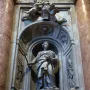 Tomb of Countess Matilda of Tuscany with a standing marble figure in an arched niche, flanked by cherubs and ornate carvings.