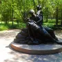 Vietnam Women\'s Memorial bronze sculpture showing two female figures tending a prone figure on a circular stone base.